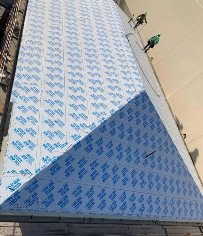 Professional roofers installing underlayment on a metal roof in North Myrtle Beach